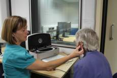 Audiologist checking patients hearing