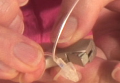 Held hearing aid open fit tubing